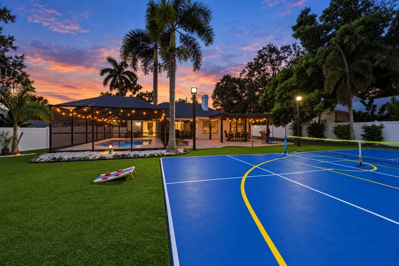 Pickleball Pool Home Retreat — Backyard, pool and pickleball court at sunset