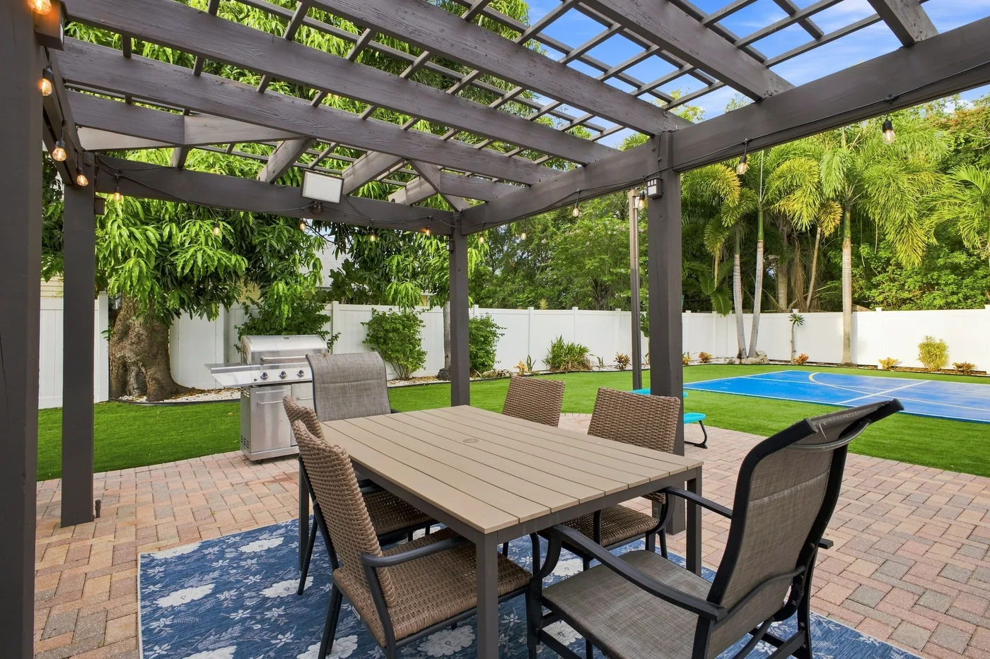 Pickleball Pool Home Retreat — Covered outdoor dining and propane grill