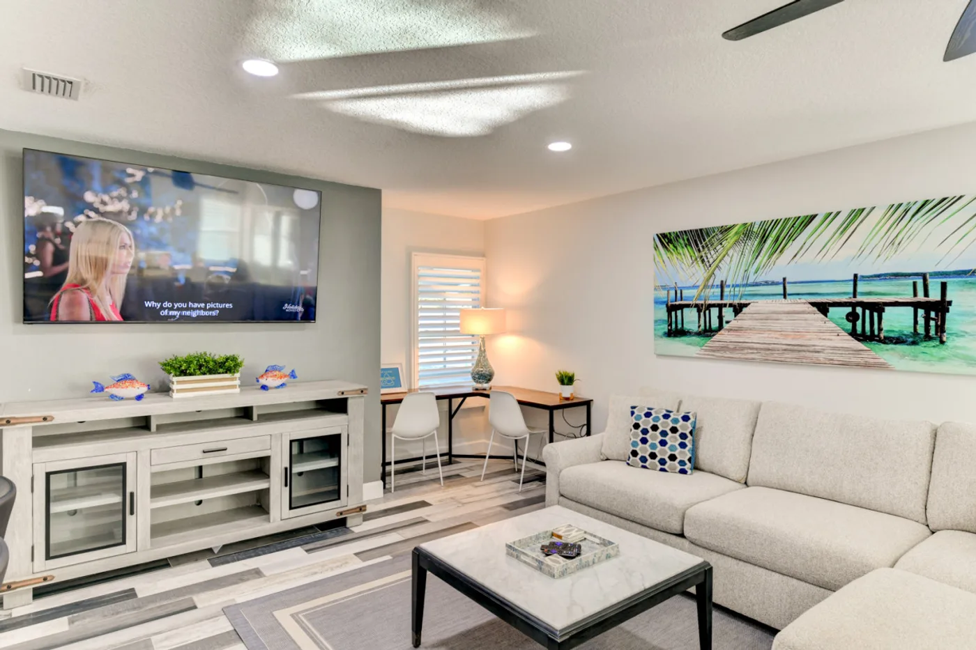 River House — Living room with a sofa, TV, and work desk